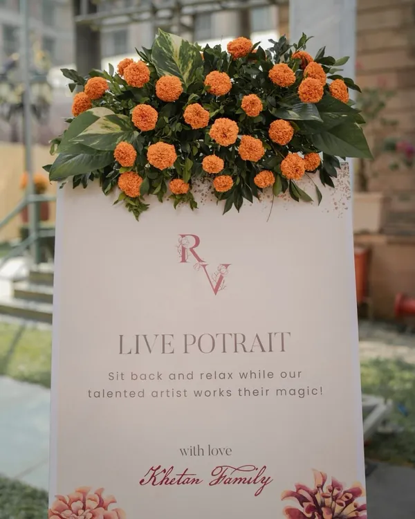 We love adding unique experiences for guests. This sign for a "Live Portrait" station invited guests to sit back and have their portrait painted, giving them a beautiful, personalized keepsake from the Haldi ceremony.