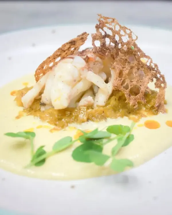 The epitome of fine dining, our confit lobster tail is served on a bed of saffron leek fondue with a corn and lemongrass velouté. This dish showcases our commitment to creating meticulously plated culinary creations for your special events.