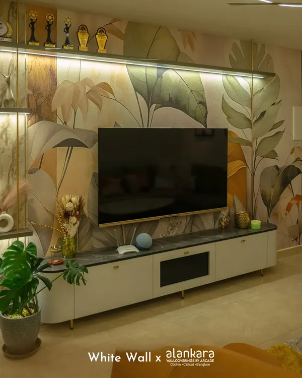 For this living room, I used a large-scale botanical wallpaper to create a stunning feature wall behind the television. The soft, earthy tones of the mural bring a sense of nature indoors and elevate the entire entertainment area.