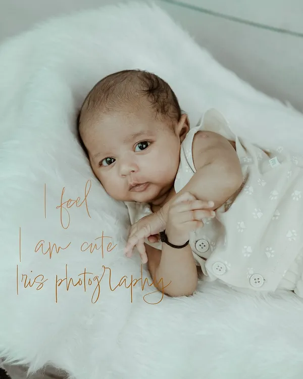 An adorable newborn portrait where the baby is awake and looking directly at the camera. This shot captures the early curiosity and delicate features of a brand new baby.