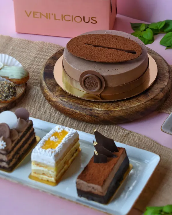 Our new menu is all set to woo you. Here's a glimpse of our coffee entremet cake alongside a selection of delicate pastries.