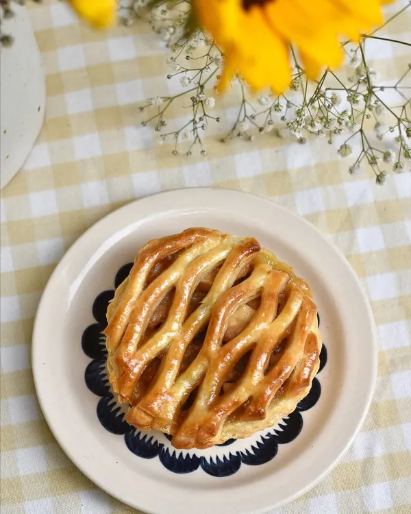 An Apple Pie with a beautiful lattice crust, a classic comfort dessert that we love to make for our weekend specials.