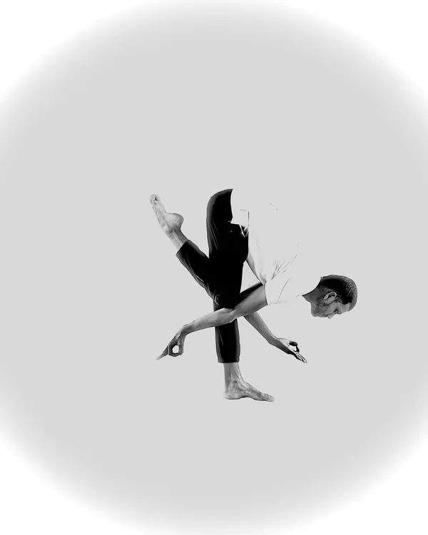 A creative and abstract balancing pose, captured in black and white to emphasize the shape and form.