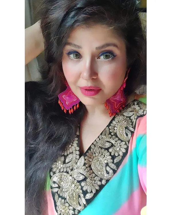 This is my rainbow kaftan, a celebration of being the best woman you can be. The vibrant colours and easy fit, paired with hand-embroidered earrings, make it a perfect piece for the festive season.