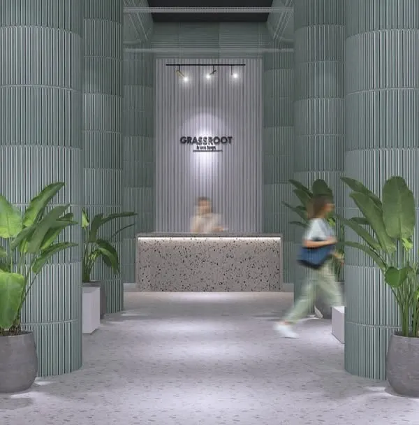 The entrance of the GRASSROOT store, designed to feel like a modern sanctuary. The combination of terrazzo, soft green columns, and plants creates a natural and welcoming threshold for shoppers.