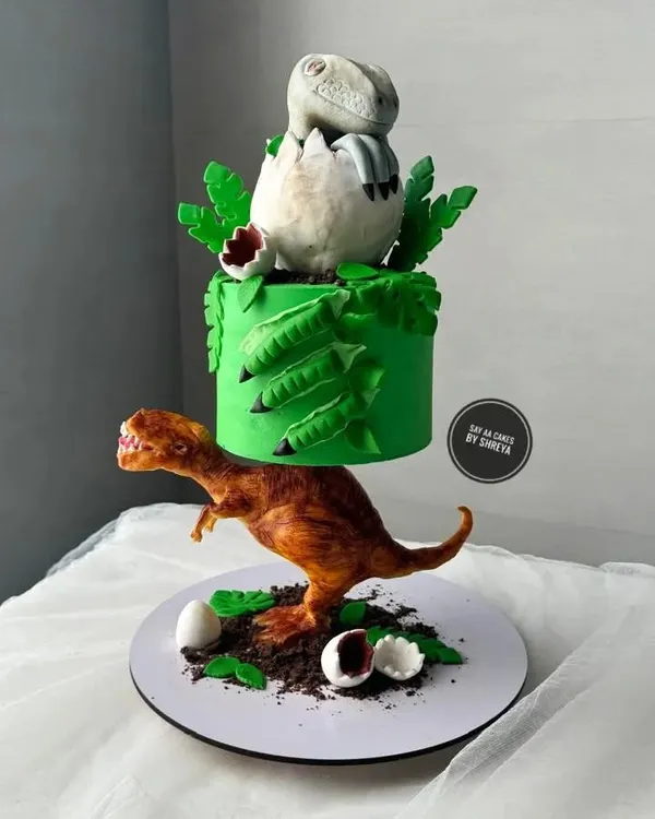 This anti-gravity dinosaur cake is a perfect example of how I love to tackle a creative challenge. The entire structure, from the T-Rex holding up the top tier to the hatching baby dino, is completely edible and designed to be a showstopper for a truly epic Jurassic-themed party.