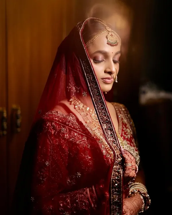 A quiet moment of reflection for my beautiful Gujarati bride, Laxmi. Her soft glam makeup, with warm tones on the eyes, was designed to complement the rich, traditional red of her wedding attire.