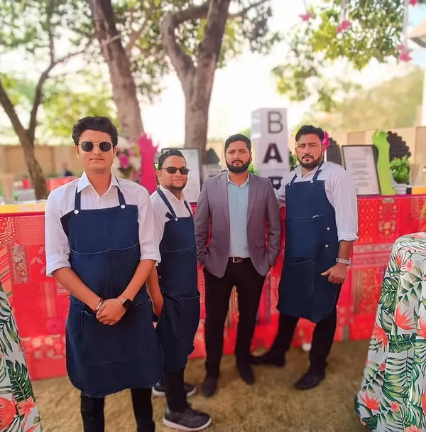 Our professional bartending team, dressed in smart uniforms, ready to serve at a beautiful destination wedding. We ensure our staff is as well-presented as our bar setups.