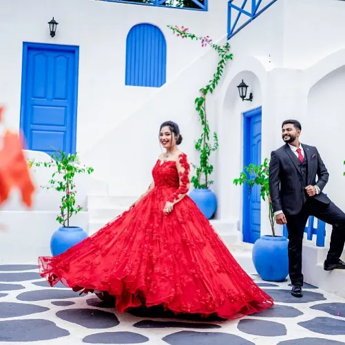 A perfect twirl in a perfect dress. This red ball gown, set against a Santorini-inspired backdrop, is made for creating those magical, cinematic pre-wedding shots.