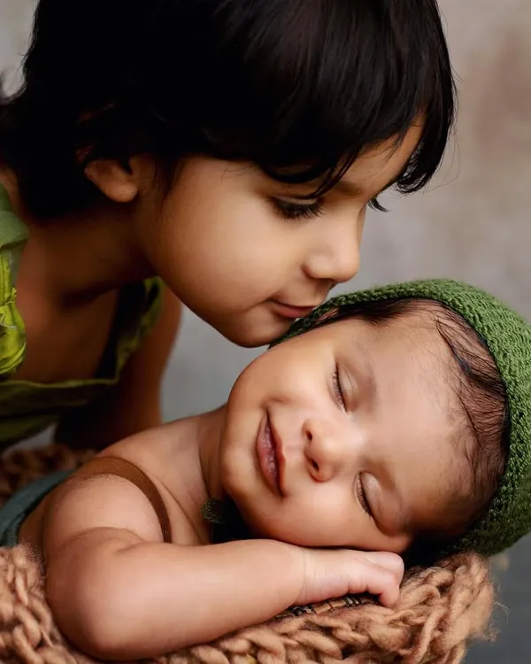 Aren't moments like these just everything? I love capturing the pure, gentle love between siblings. This big sister was so in awe of her new baby brother, and that little smile on his face is just priceless. These are the sibling photos you'll treasure forever.