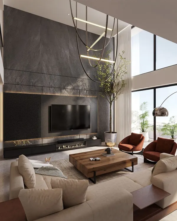 For this Pune apartment, I designed a dramatic living space with a double-height ceiling and a striking stone-clad feature wall. The modern fireplace and custom television unit are integrated seamlessly, while the sculptural chandelier adds an artistic focal point.