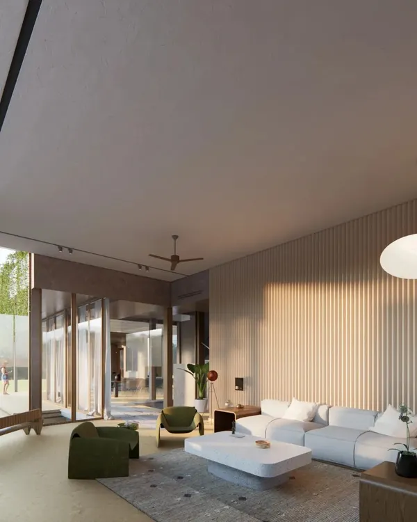 A render of the living space for the upcoming Sanctuary Residence. The design features fluted wood walls and large pivoting glass doors that open completely to the landscape, creating a single, unified space for living indoors and out.