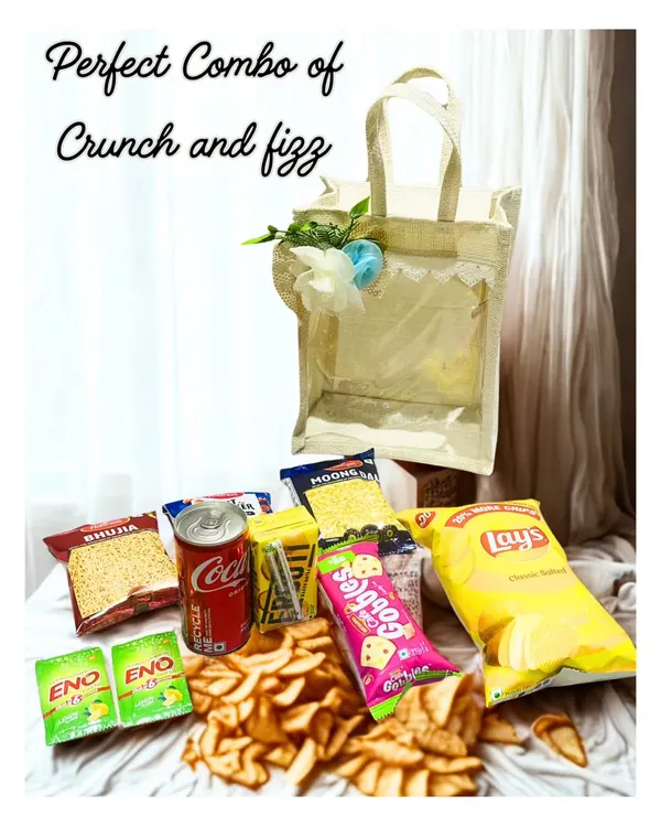 The perfect combo of crunch and fizz. This hamper shows all the goodies unpacked, from Lay's and bhujia to Coca-Cola and Frooti.
