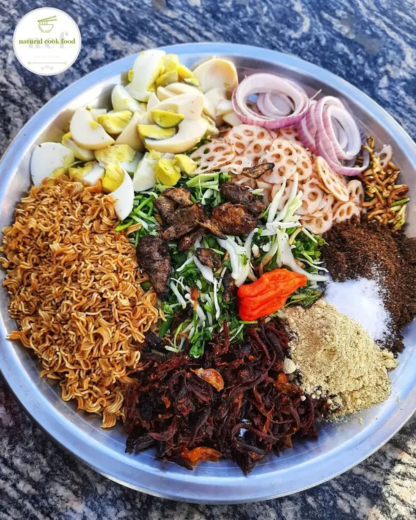 This is how I prepare my authentic Manipuri 'Singju'. It's a spicy salad with a mix of fresh vegetables, crispy noodles, boiled eggs, and roasted powders.