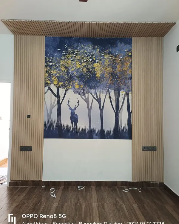 I combined light-colored fluted panels with a custom forest mural to create this striking accent wall. This mixed-material approach adds depth and character, turning a plain wall into a central feature of the living room.