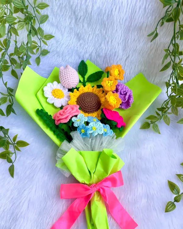 This vibrant bouquet is a burst of happiness, handmade with so much love. It features a mix of my favorite flowers: a cheerful sunflower, delicate roses, a lovely tulip, and other colorful blooms, all wrapped in bright neon green paper to make someone's day extra special.