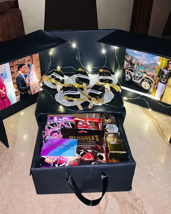 This is the ultimate surprise box, designed to create a truly unforgettable moment. It features backlit photo panels that light up to reveal your favorite memories, a drawer filled with premium chocolates and gifts, and even custom-named cakesicles for that extra personal touch.