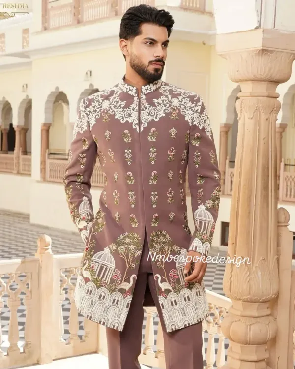 A unique sherwani in a muted mauve tone, featuring intricate white embroidery depicting a story with bird cages and floral motifs. This is a perfect example of how I can turn a personal vision into a wearable masterpiece.