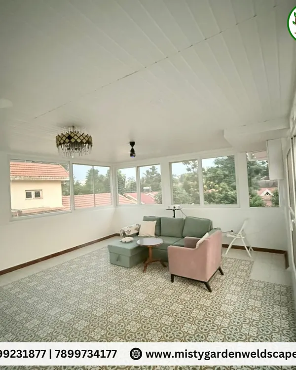 The interior of a completed terrace room, showing how the space is filled with natural light from large windows, creating a bright and airy living area with views of the neighborhood.