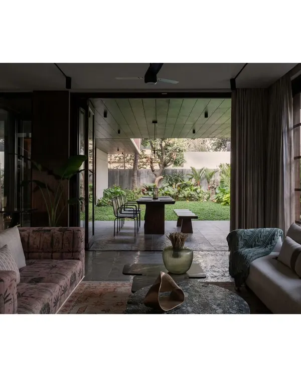 This is what we live for: erasing the lines between the indoors and the beautiful world outside. We designed this living area to flow seamlessly into the garden, creating a space that feels both expansive and intimate. It’s a perfect example of our belief in natural light home interiors and creating a tranquil, earthy atmosphere.