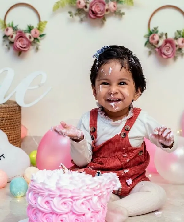 This is the moment it's all about. We capture the pure, uninhibited joy of a first birthday cake smash, complete with frosting-covered smiles. This studio session in Gurugram is set up for maximum fun and easy cleanup.