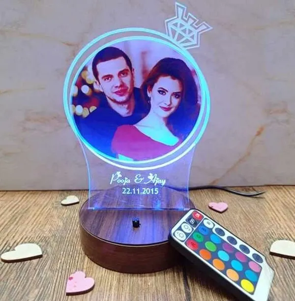This custom LED photo lamp is a perfect gift for anniversaries or birthdays. I can engrave your names and a special date below your favorite photo, and you can change the light color with the included remote to match any mood.