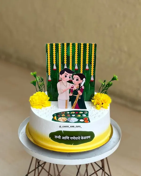 A beautiful cake for a "Kelvan" ceremony, a Maharashtrian pre-wedding tradition. We created a custom topper of the couple in traditional attire to make it extra special.