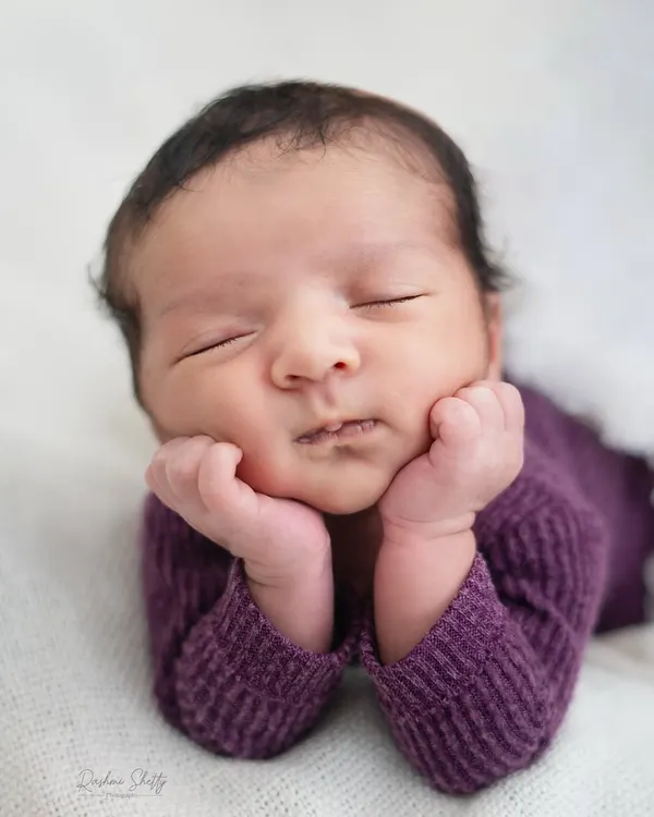 The perfect newborn pose, with tiny hands gently framing a peaceful, sleeping face. I patiently work to capture these serene moments, highlighting the pure innocence of your baby's first days.