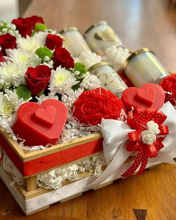 This custom hamper was a joy to create. It's overflowing with fresh red and white flowers, surrounding my heart-shaped and rose-shaped candles, along with some classic jar candles.