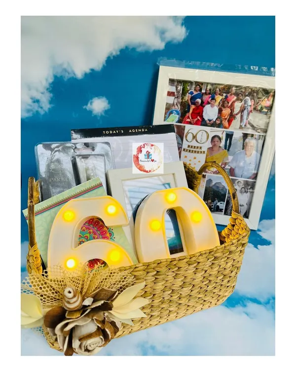 A milestone 60th birthday basket filled with personalized memories. This hamper features a large photo collage frame and light-up LED numbers.