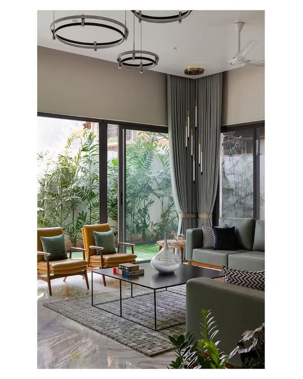 The living areas in the 'Solid Void Solid' house are designed as open, fluid spaces that connect directly to surrounding gardens. We used large glass panels and a neutral color palette to enhance the sense of spaciousness and draw the verdant landscape into the home's interior.