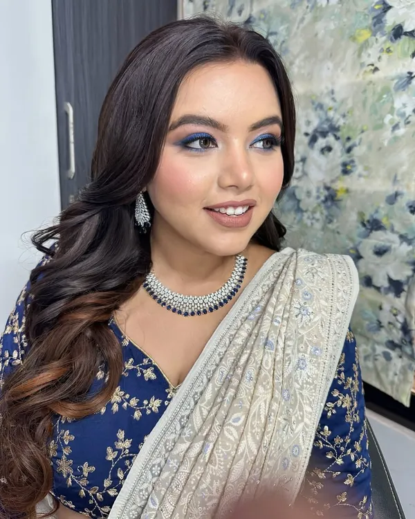 For this client's meet and greet event, we went for a bold blue smokey eye. It's a fantastic way to add a pop of color and drama, especially when paired with a classic saree.