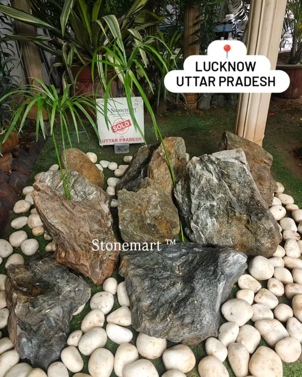 A beautiful arrangement of our natural stone boulders surrounded by contrasting white pebbles. This is the foundation of a classic Zen garden, creating a space of peace and contemplation for a client in Lucknow.