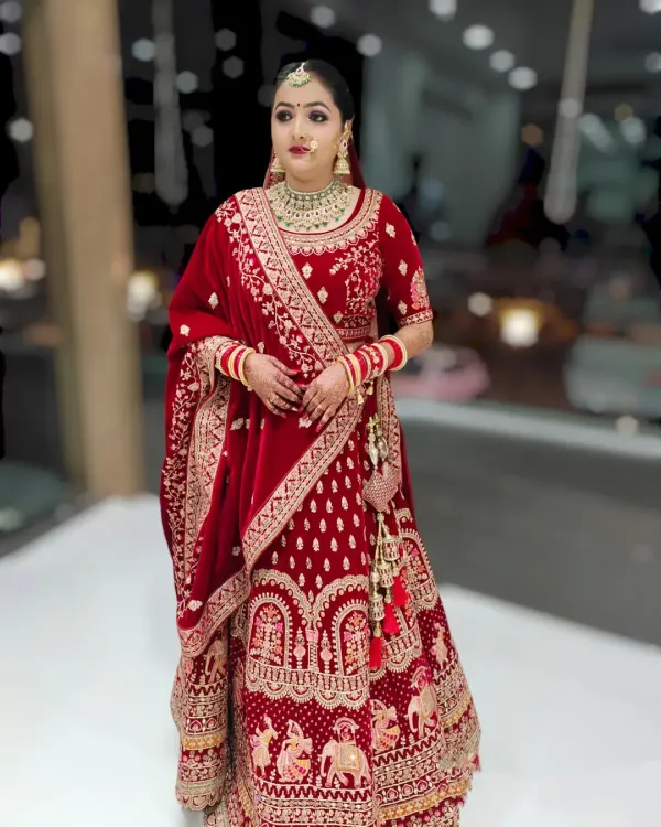 A full view of a classic bridal look I created, featuring a radiant base that complements the rich velvet of the red lehenga. The makeup is designed to be picture-perfect from every angle, highlighting the bride's features while matching the grandeur of her wedding attire.