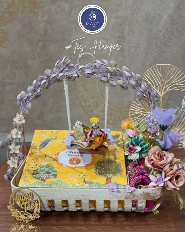 I believe every festival deserves to be celebrated with grace. This handcrafted Teej hamper, with its delicate swing and traditional dolls, is designed to be more than a gift; it's a beautiful story of love and festivity, perfect for your dearest ones.