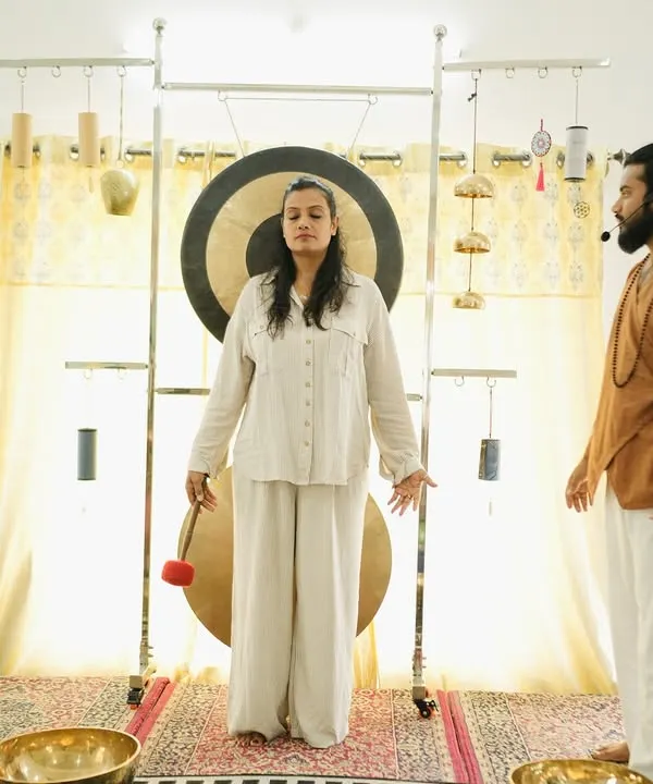 A student experiences a gong bath, a powerful technique for deep vibrational healing.