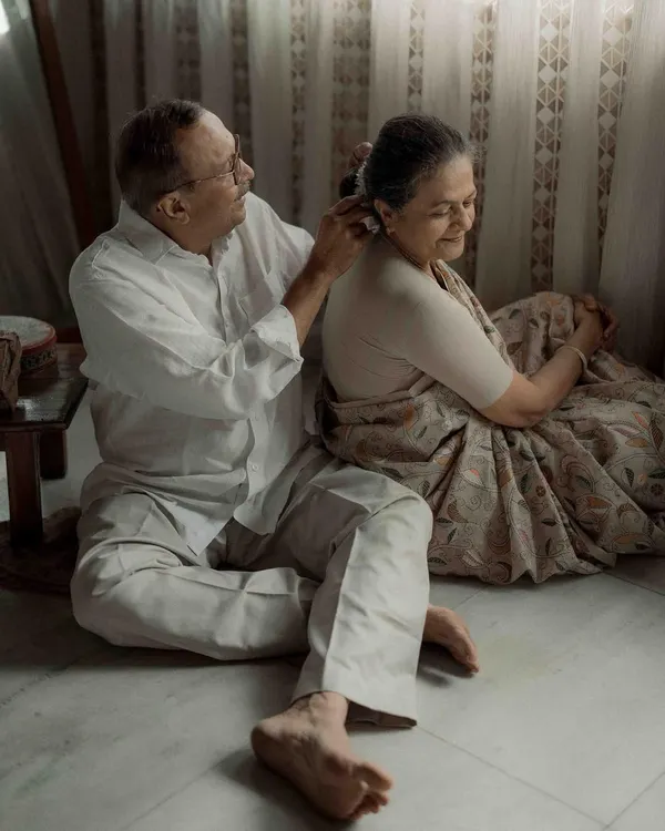 A simple, tender gesture of him placing a flower in her hair. It’s in these quiet moments that a lifetime of love speaks the loudest. This is the kind of authentic connection I strive to capture.