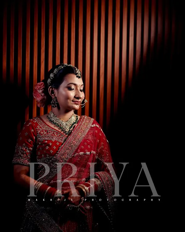 I love using creative lighting to make my bridal portraits stand out. Here, the dramatic shadows and warm light create a serene and elegant portrait of the bride, Priya.