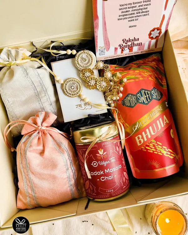 Our 'Laad Pyaar' Rakhi hamper is all about celebrating the bond between a 'bhaiya' and 'bhabhi'. It's packed with masala chai, bhujia, dry fruit potlis, and a stunning handcrafted lumba rakhi set.