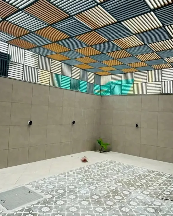 This unique project features a custom-designed louvered ceiling with a multi-color checkerboard pattern. It's a perfect example of how a pergola can be a functional piece of art, controlling light and adding a dramatic visual element.
