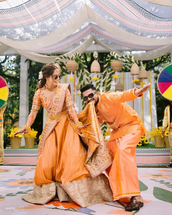 The groom playfully dances with his 'param sundari' during their Haldi ceremony. A riot of color, laughter, and love.