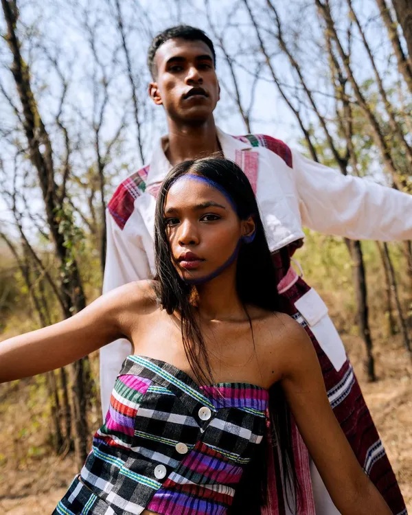 From the 'Nazaar' editorial, this outdoor portrait features two models in a strong, confrontational pose, blending fashion with a raw, natural setting.