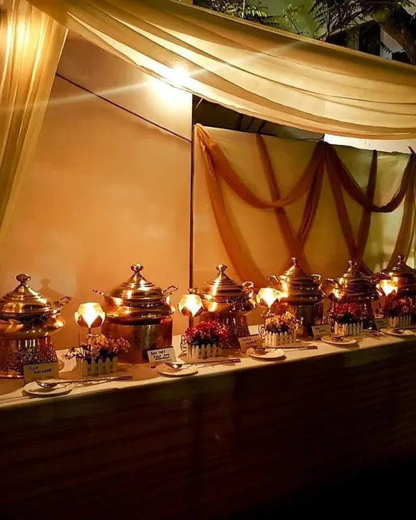 This is the elegant, full-service buffet setup I bring to your parties. I use traditional copper serving dishes and warm lighting to create a festive atmosphere, so you can host a grand celebration without the stress.