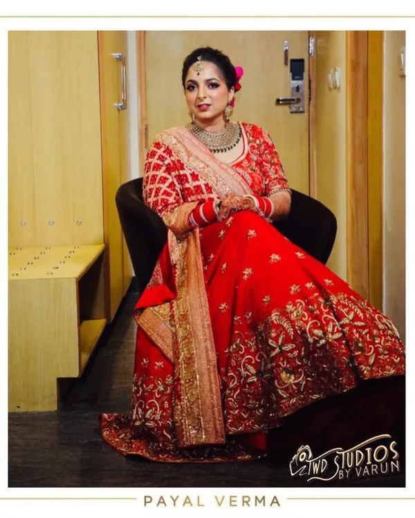 A moment of quiet reflection before the ceremony. The bride looks regal in her custom red Dabka and pearl embroidered lehenga, a design we collaborated on to match her vision perfectly.