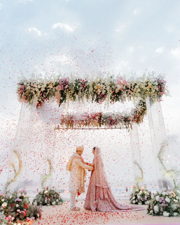 This is what it feels like when love meets the ocean. A perfect moment under a sky-high floral mandap, showered with petals, as two people begin their forever. This is the kind of magic I strive to capture.