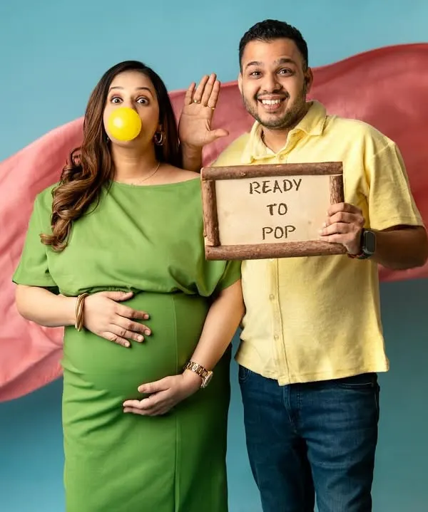 "Ready to Pop!" This is such a fun and playful concept for a maternity shoot. The bubblegum and the cute sign add a touch of humor and personality to their announcement photos.