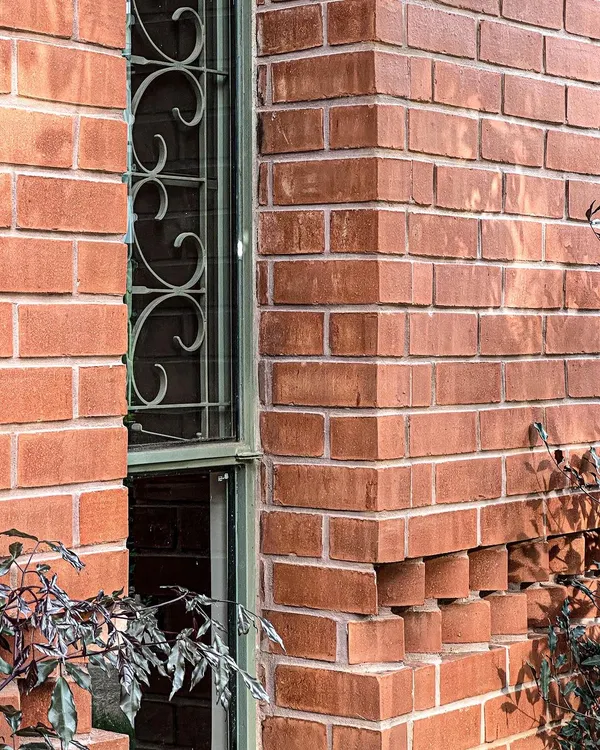 We often explore the sculptural possibilities of common materials. This detail from the Ferns Cottage shows a projecting brick pattern that creates intricate shadows and adds a unique texture to the facade.