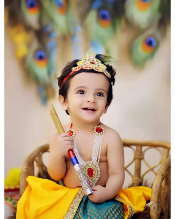 A joyful portrait from our popular Krishna-themed photoshoot. We use colorful backdrops with peacock feathers and provide detailed costumes to bring the story of little Krishna to life.