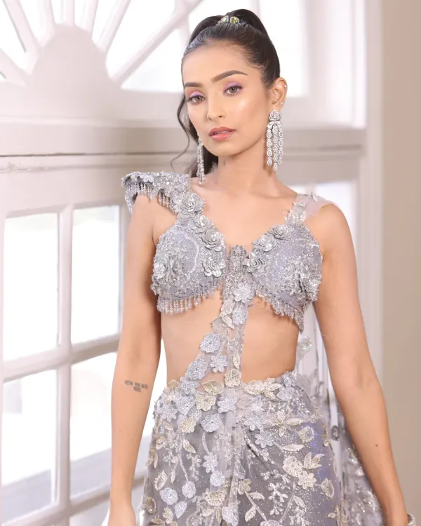 Creativity is key in makeup. This modern look with a unique silver-grey outfit and dramatic earrings is perfect for a fashion-forward client.