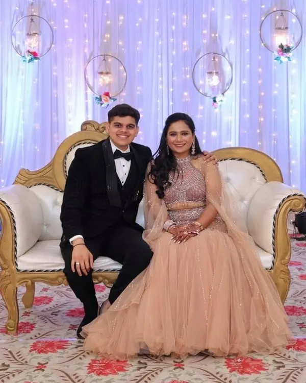 This peach fish-cut lehenga with a cape-style dupatta is a perfect fusion of modern silhouette and traditional sparkle. It’s a glamorous choice for a reception or engagement, and I also offer coordinating tuxedos for a complete couple's look.
